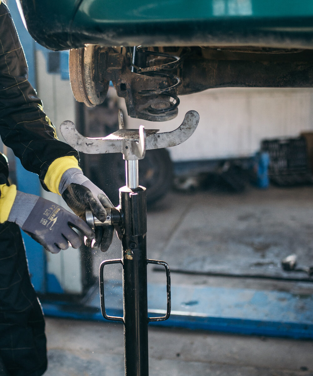 Mechanic servicing a vehicle's suspension